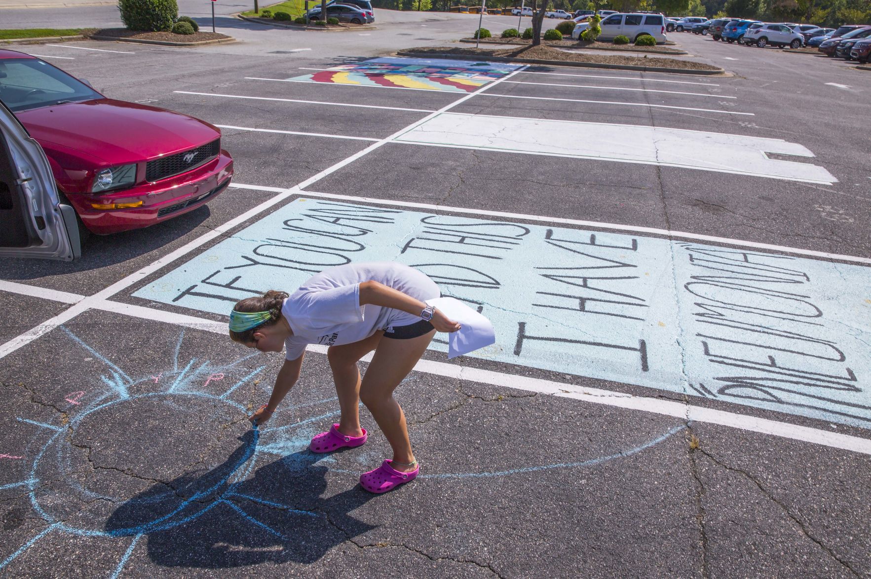 Students painting their parking spaces